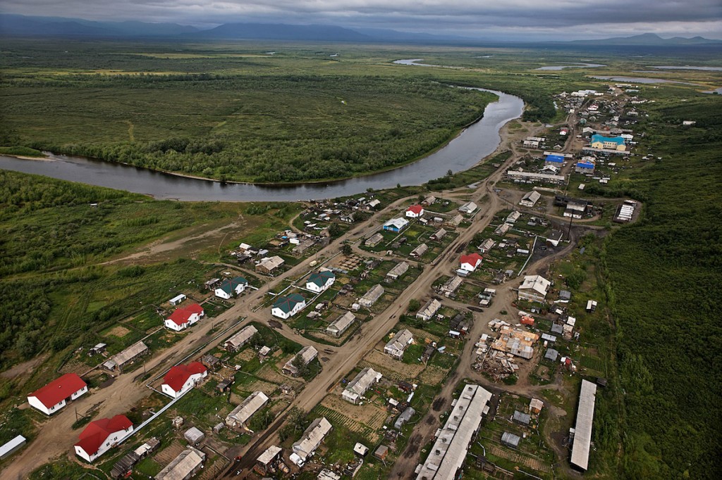 aerial photo showing buildings in a small community along a river in a remote location