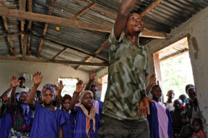A Bantu organizes a Pygmy choir in a church in Epulu | DR Congo